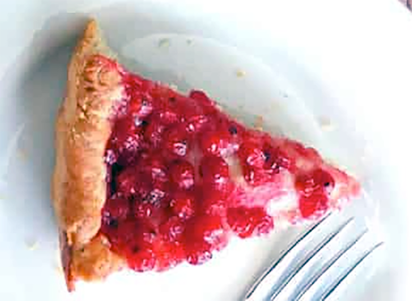 wedge of german redcurrant cake on a plate with a fork