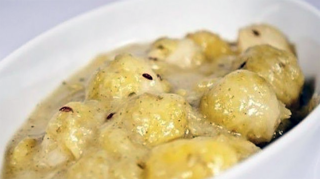 brussels sprouts in sour cream in a white baking dish