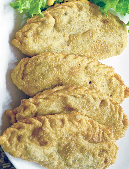 fried Mongolian Muhammara pasties arranged on a plate