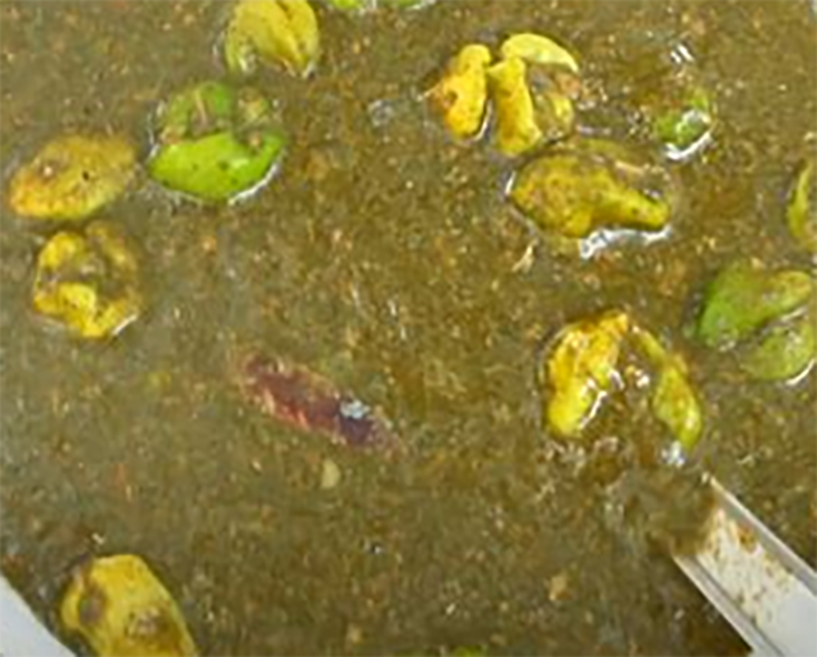 Togolese stew of baobab leaves with whole hot chillies