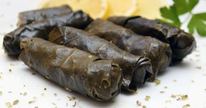 stuffed vine leaves arranged on a plate
