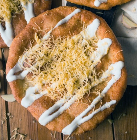fried breakfast flatbread served topped with soured cream and cheese