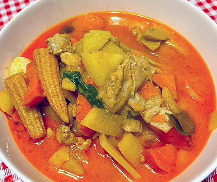 Lao red curry of chicken and vegetables served in a bowl