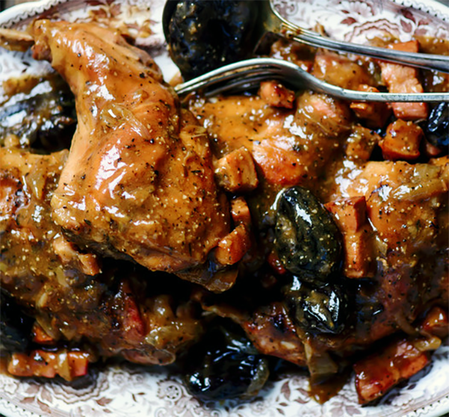 Rabbit stewed with prunes served on a plate