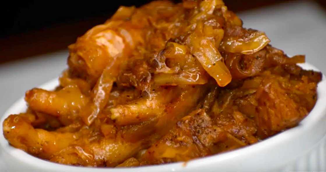 liberian dish of prawns, chicken, smoked turkey and smoked/dried fish fried with cabbage in a spiced tomato puree base