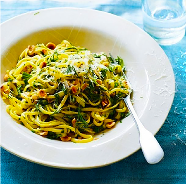 linguine with saffron, roasted garlic, herb butter and hazelnuts served in a pasta bowl
