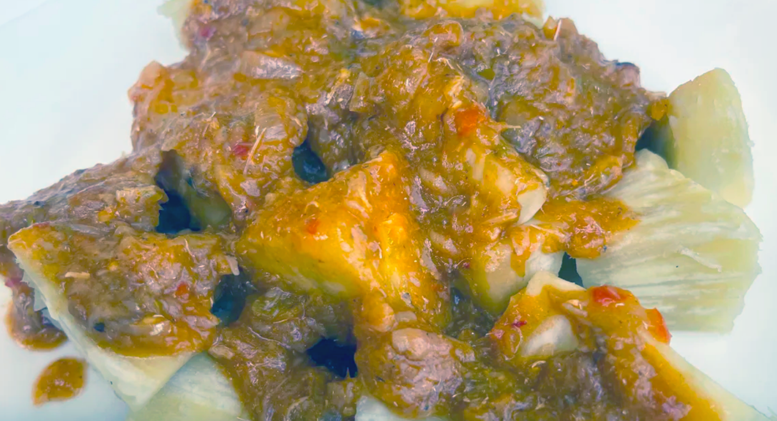 Breadfruit pieces served topped with a tinned mackerel, onion, chilli and oil sauce