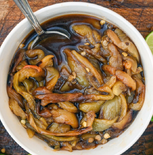 Marinated chile guerito peppers in a bowl with  spoon