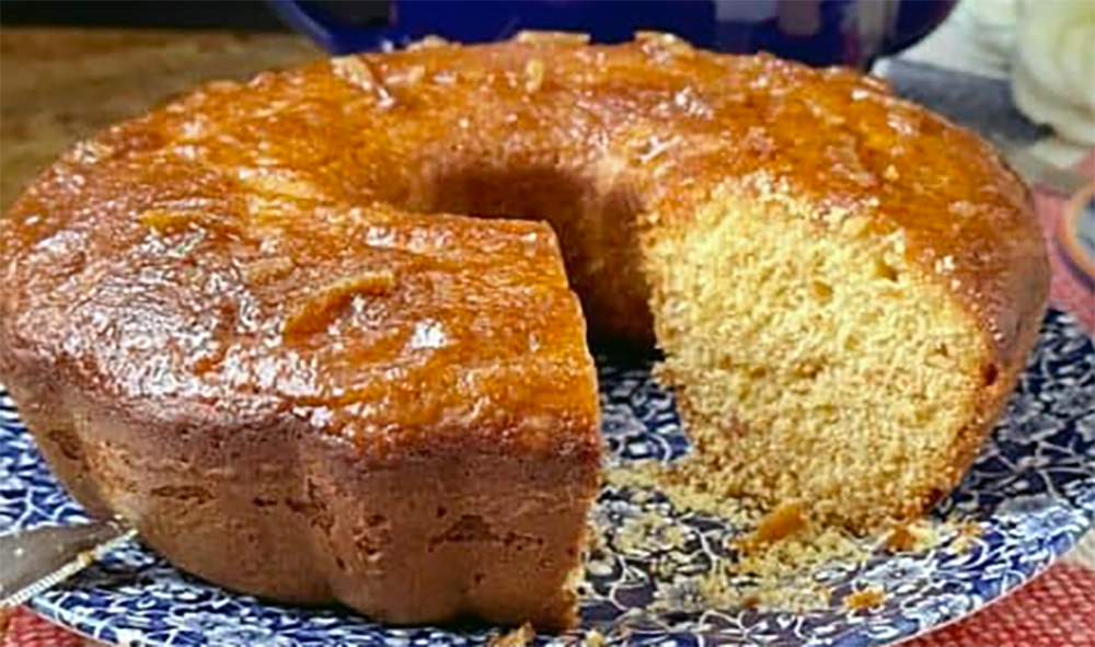 marmalade ring cake on a plate with one slice removed to reveal the centre