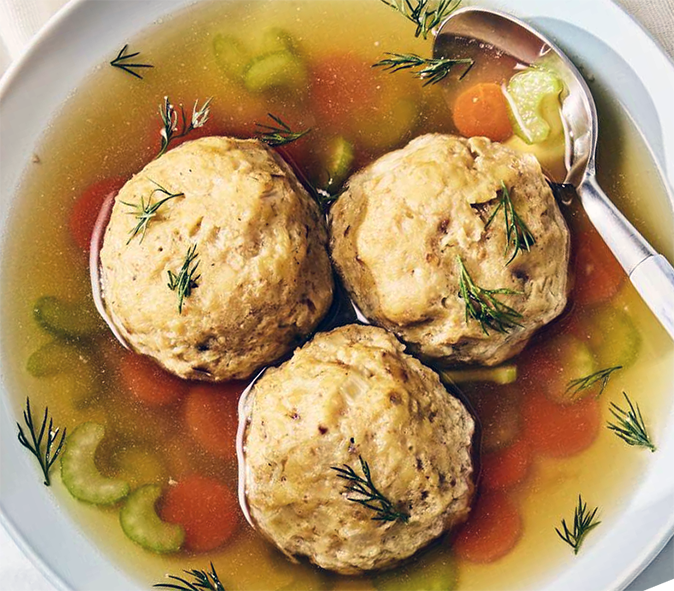 soup with three matzo balls in a bowl