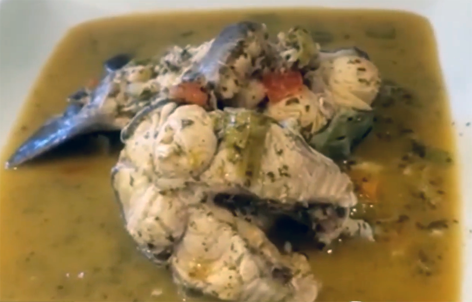 African carp steaks in a mushroom-based sauce in a white dish