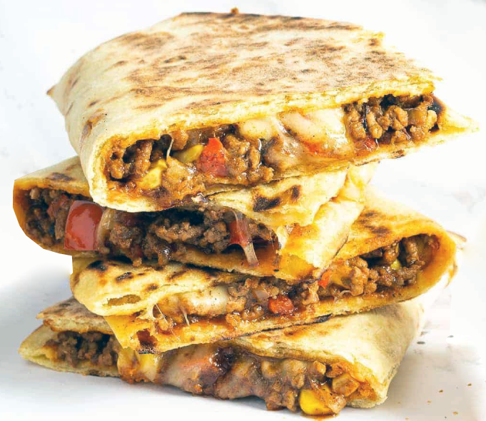 two mexican beef quesadillas cut in half and stacked on top of tach other