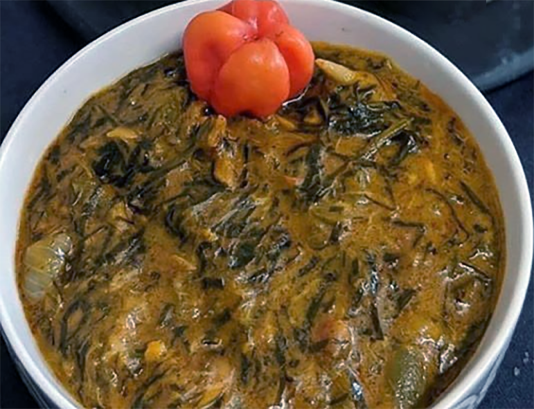 mfumbwa stew garnished with a whole chilli in a bowl