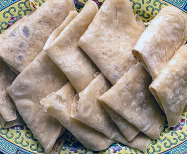 moo shu pancake triangles arranged, overlapping, on a plate