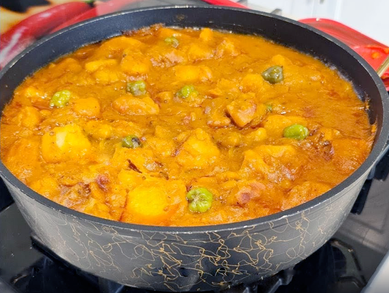 ghanaian yam porridge in a spiced tomato base served in a large blue bowl