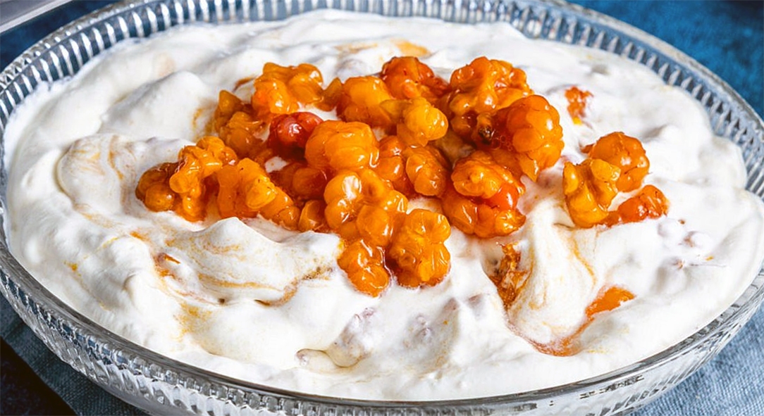 cloudberry preserves served on whipped cream flavoured with vanilla and lavender in an oval glass dish
