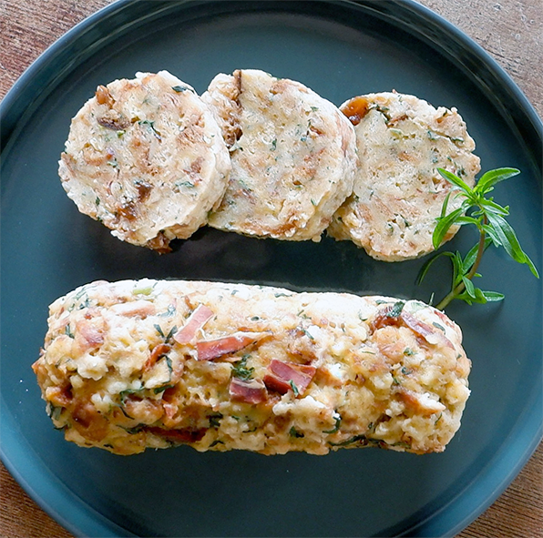 Istrian Nakelda bread roll on a plate with three slices of the roll set above