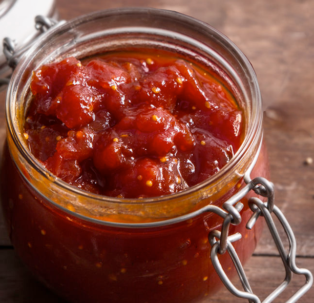 Red tomato chutney in a clip-top jar