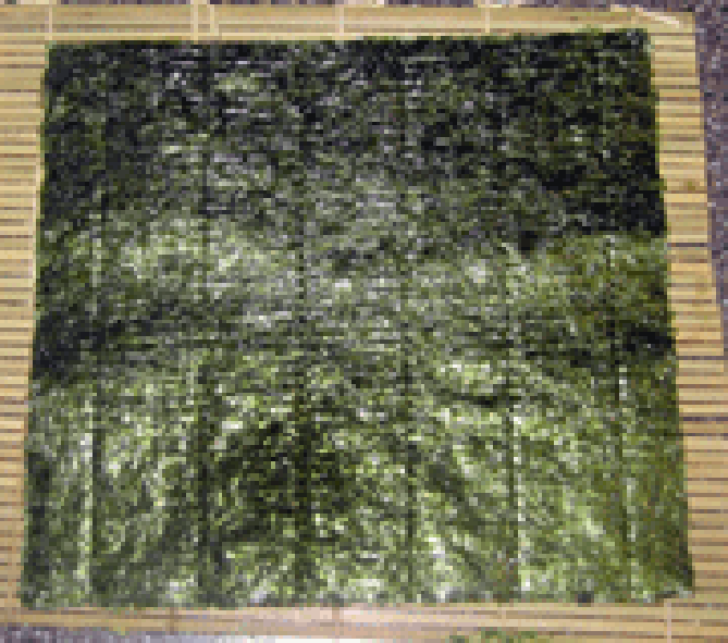 Sheet of dried nori on bamboo mat