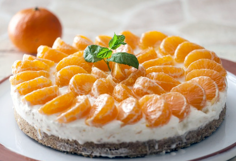 Whole cheesecake, served topped with clementine orange segments