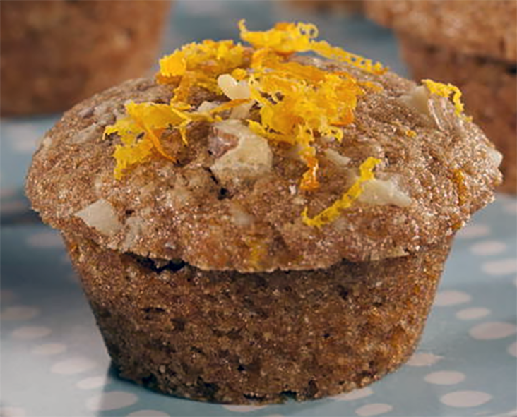 orange walnut breakfast muffin served topped with grated orange zest