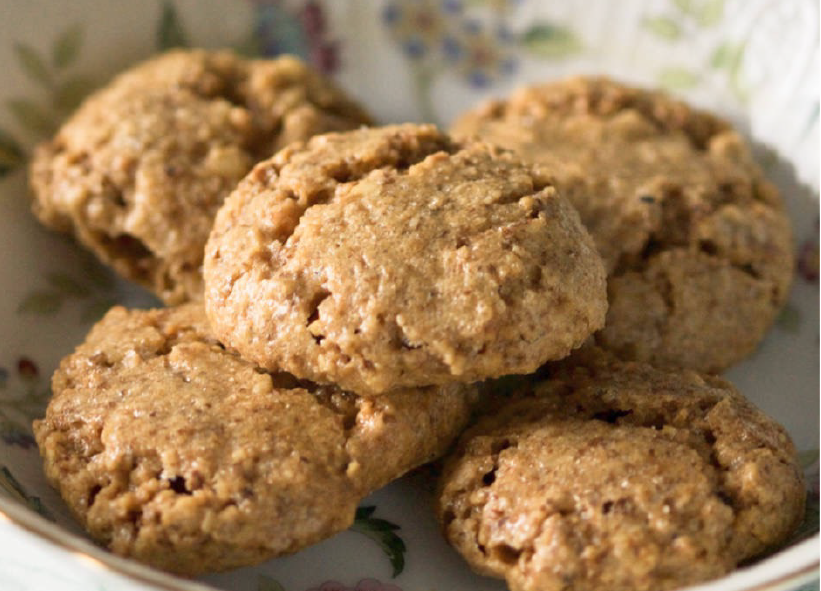 five Bosnian walnut biscuits piled on a plate