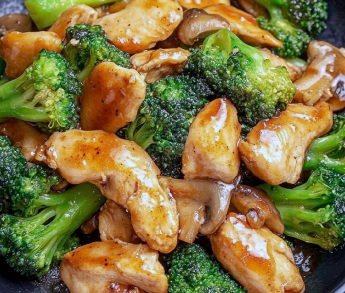 oriental chicken strips stir fried with broccoli served on a plate