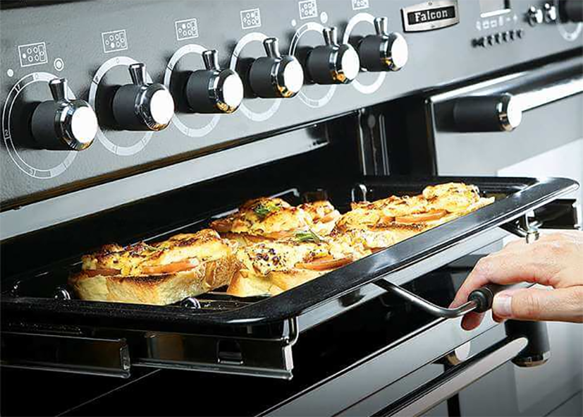 Food cooking under an oven grill.