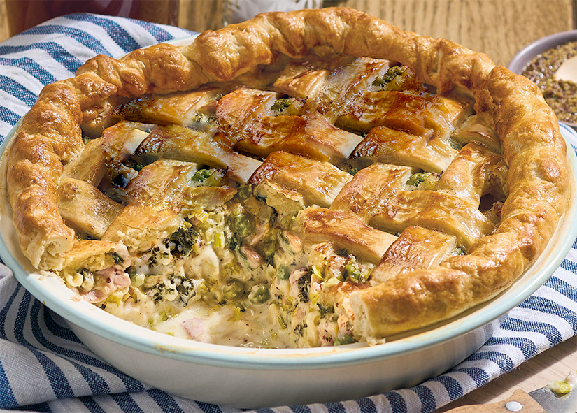 limpet, bacon and leek pie with a lattice crust, one slice removed to reveal the filling