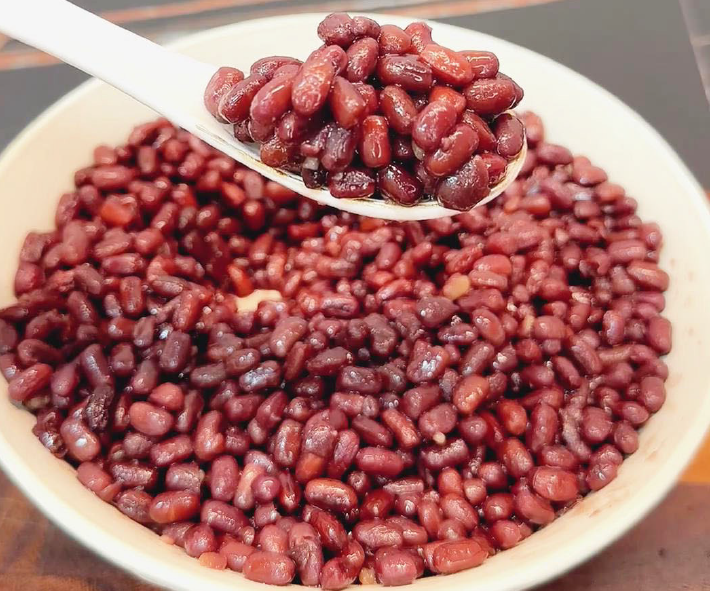 sweet red beans on a plate with some lifted on a spoon