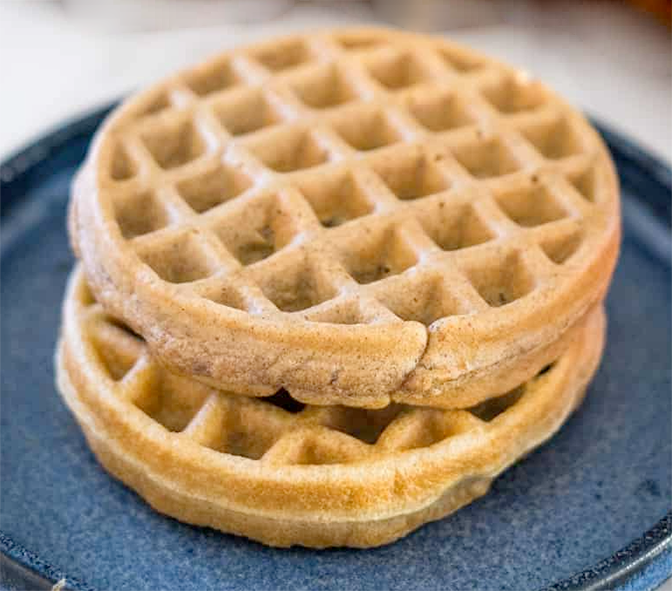 two peanut butter waffles arranged on a blue plate
