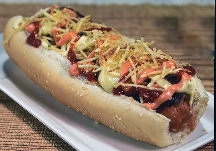 Arizona-style hot dog, perro caliente on a white plate