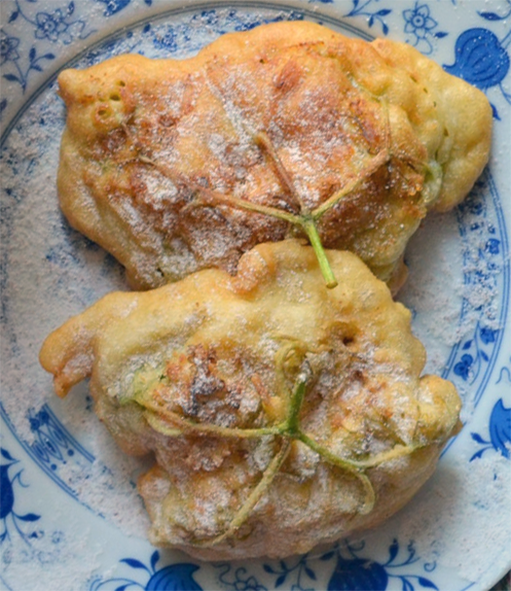 two elderflower pancakes served on a plate