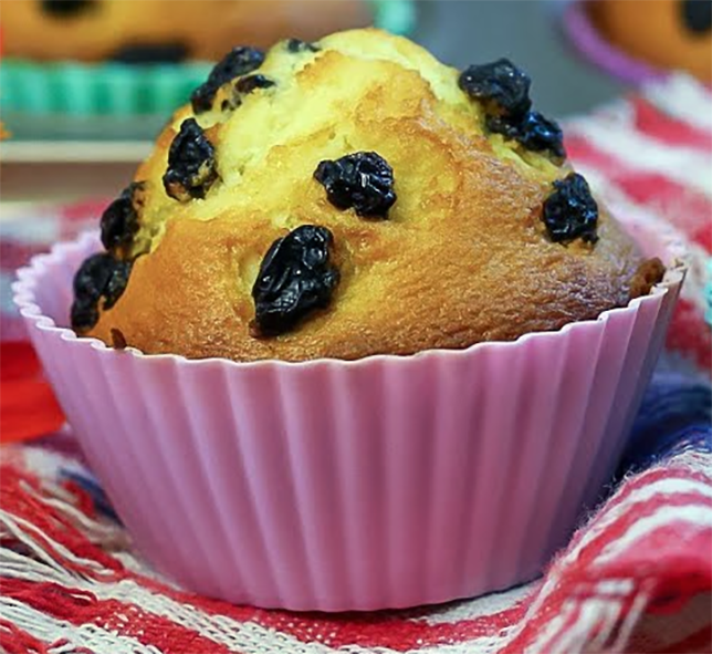 white cupcake with raisin polka dots