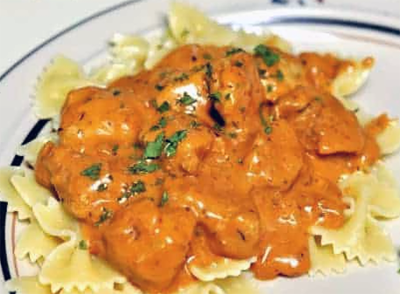 pork paprikash on a bed of farfalle pasta