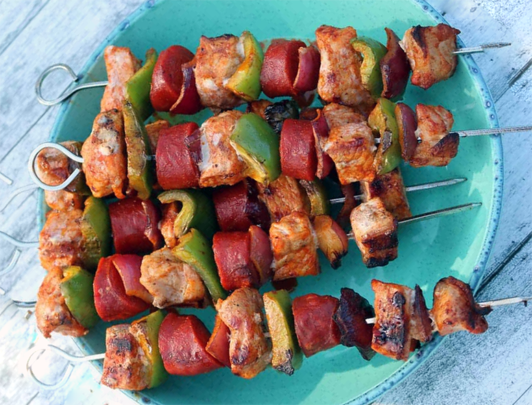 pork and chorizo kebabs on skewers served on a plate