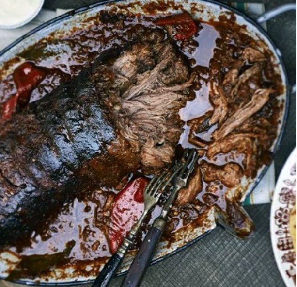 rolled beef brisket coated with spice paste slow cooked in a tomato-based sauce