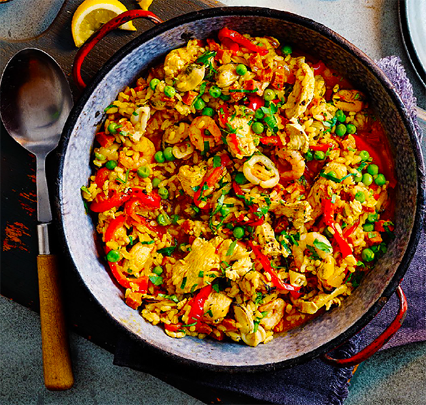 quick valentine's day paella served in a bowl with a spoon next to it