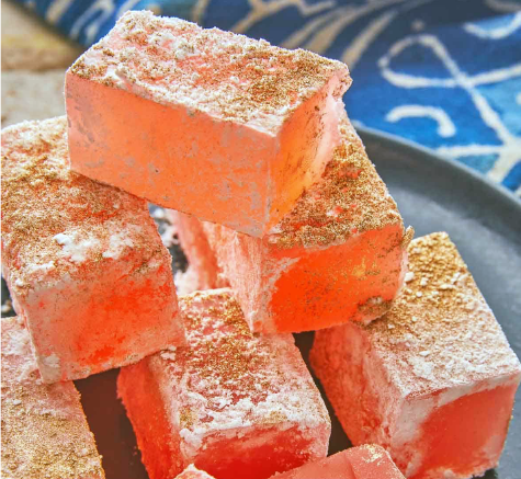 rectangular pieces of rahat lokum sweetmeats piled on top of one another