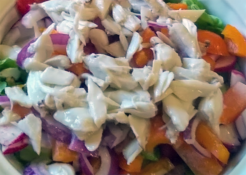 salad of corned been on a bed of vegetables dressed with coconut cream