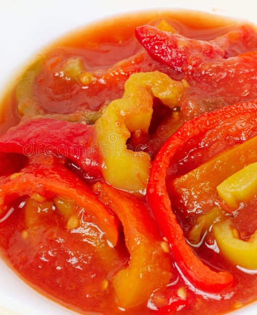 onion and bell pepper cooked with tomato and paprika served in a bowl