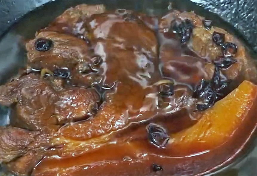 red-cooked pork shoulder in a wok