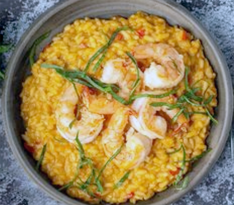 image of a red curry with prawns, Thai-Italian fusion dish.