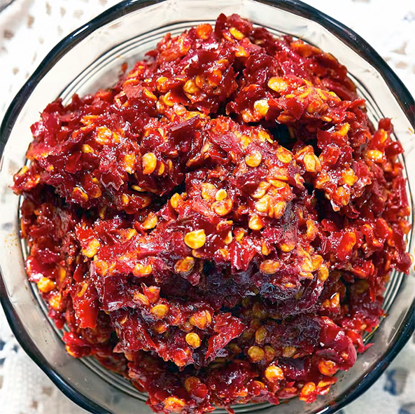 red schug condiment in a glass bowl