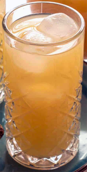 rooibos-based ginger beer in a tall glass with ice