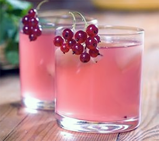 redcurrant juice served in tumblers garnished with a sprig of redcurrants 