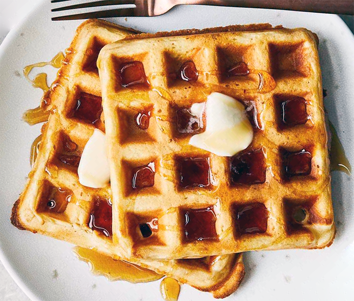 waffles made with reedmace pollen on a plate drizzled with syrup