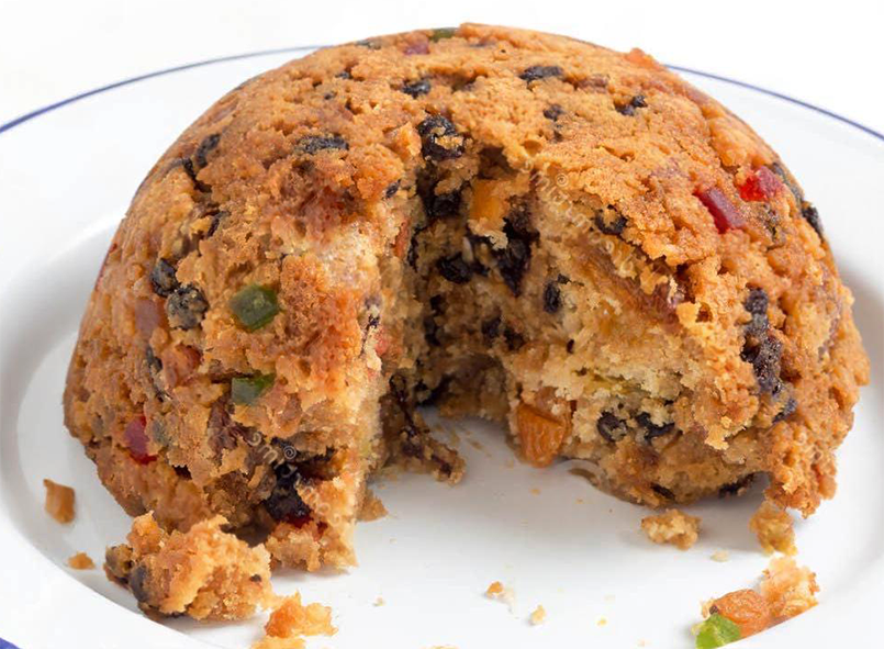 steamed rick collegiate pudding on an enamel plate