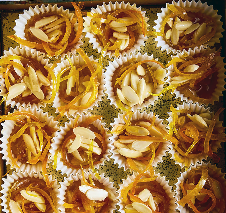 saranzada, Sardinian orange and almond sweetmeats presented in mini cupcake cases on a tray