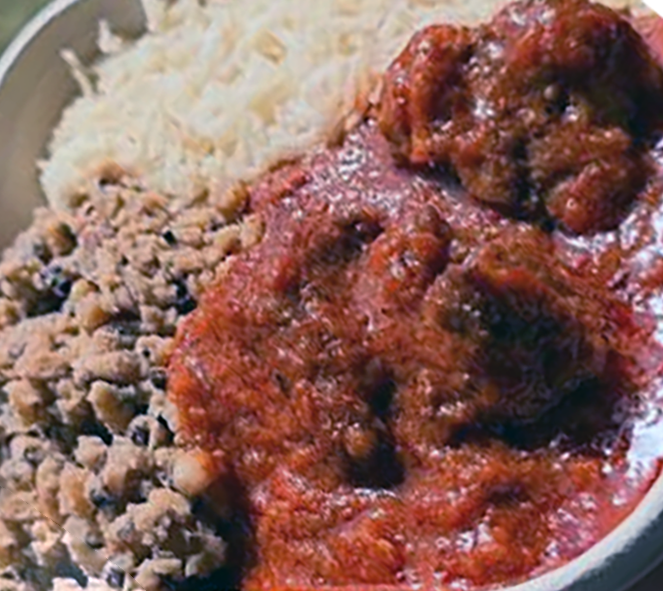 goat meat stew served with rice and black beans and white rice